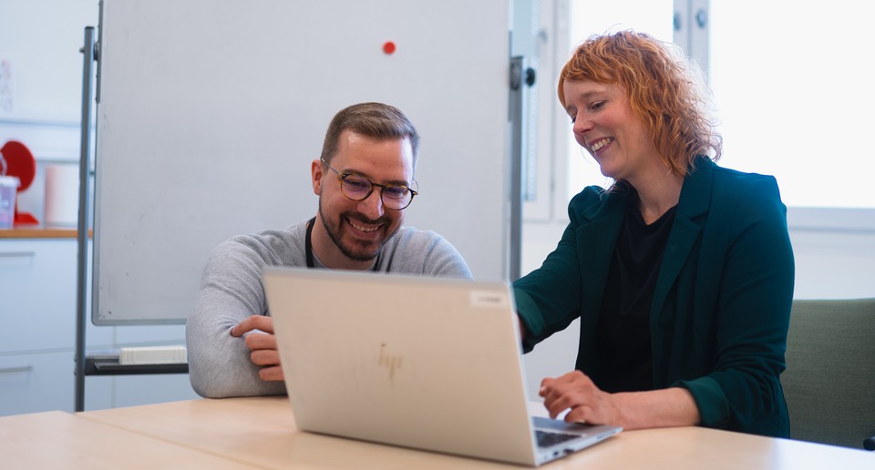 Två medarbetare samarbetar vid dator. 